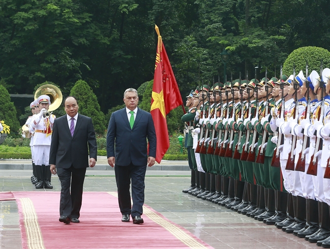 Hungarian Prime Minister Orbán Viktor and his wife pay an official visit to Việt Nam from September 24-26.The visit is made at the invitation of Prime Minister Nguyen Xuan Phuc. During the visit Vietnam and Hungary would seek ways to step up bilateral cooperation in economy trade investment science-technology education-training healthcare environment security and defence. In the photo: The two prime ministers review the guard of honour in Hanoi on September 25. Photo: Thong Nhat/VNA