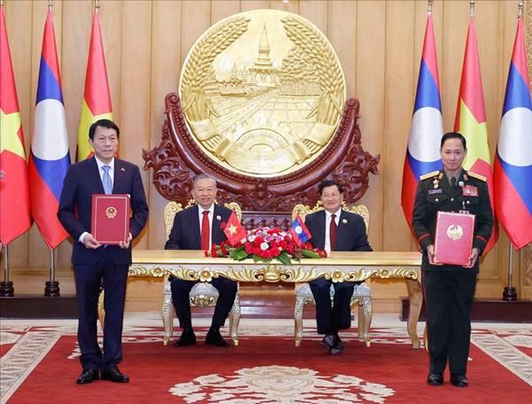 Vietnamese, Lao top leaders witness exchange of cooperation documents