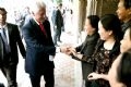 Former President Bill Clinton shakes hands with the Hanoians.