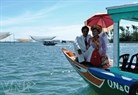 A newly-wed couple taking a boat at Cua Dai.