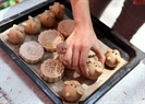 Moon cakes made by children are ready for being grilled. Photo: Cong Dat.