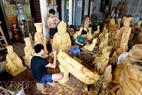 Each artisan takes responsibility for a part in the process of carving statues.