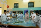 Visitors look at the model of Con Dao Island.  