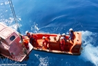 A high speed canoe takes workers of oil tanker MV12 to approach a lifeboat.