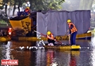 Workers check and mark dredging sites. Photo: Cong Dat